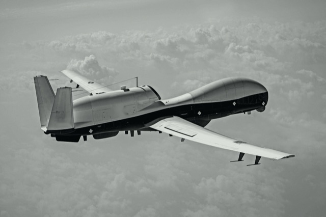 Uncrewed aircraft in flight, black and white
