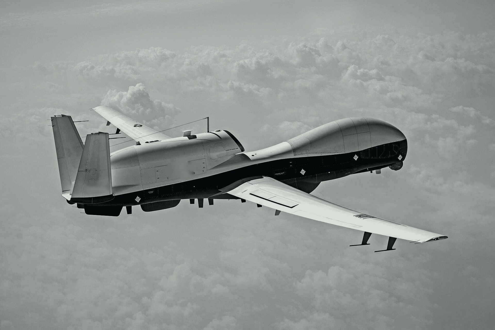 Uncrewed aircraft in flight, in black and white