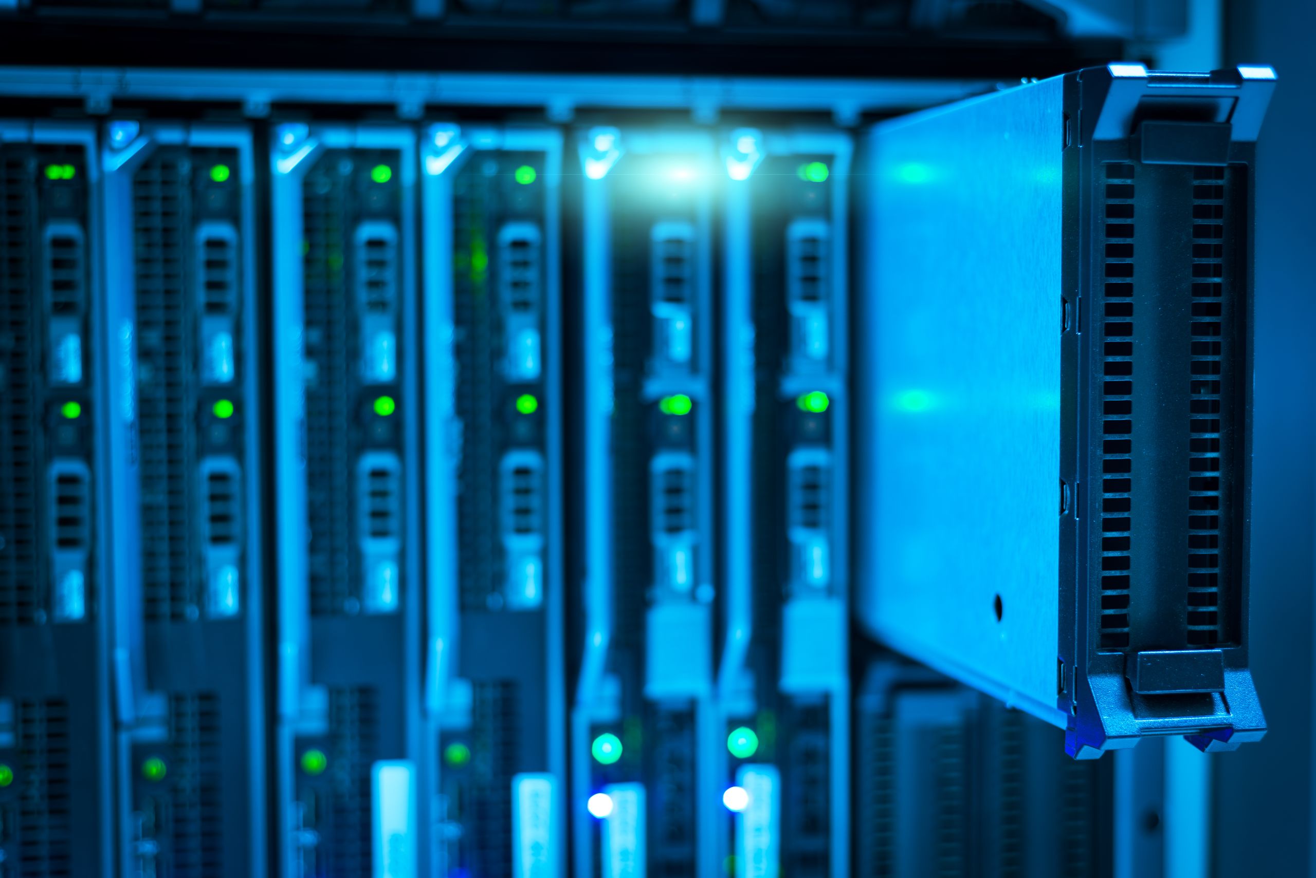 Racks of servers lit in blue, with rows of status lights seen at a steep angle.