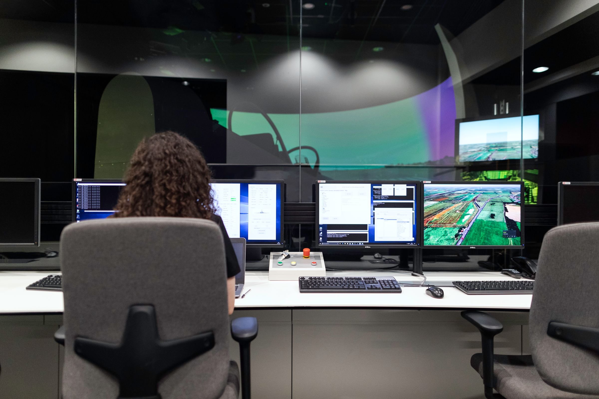 An engineer at a bank of monitors in a grid control room