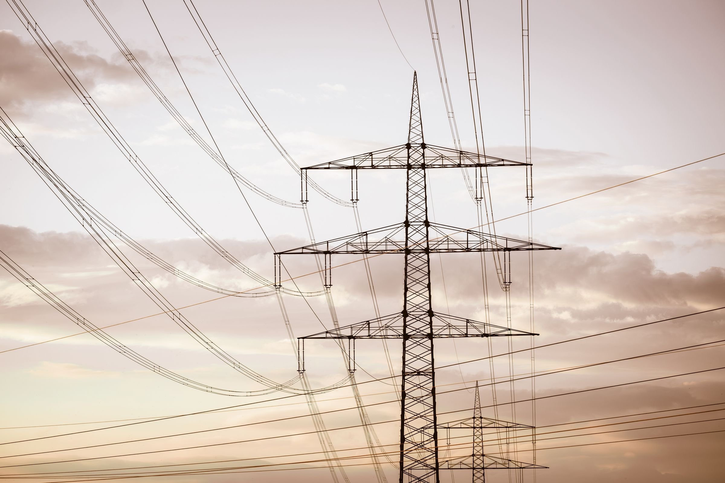 Electricity pylons and power lines at sunset