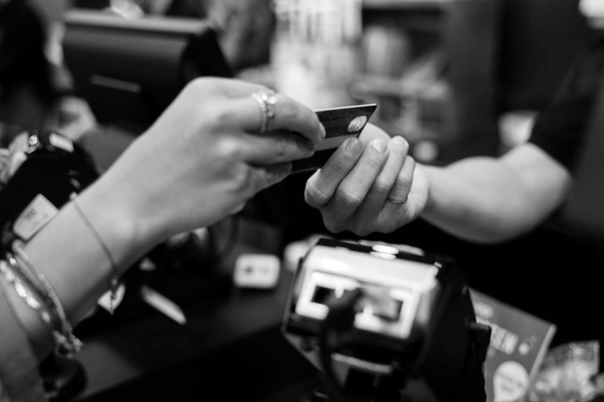 A customer paying by card at a till
