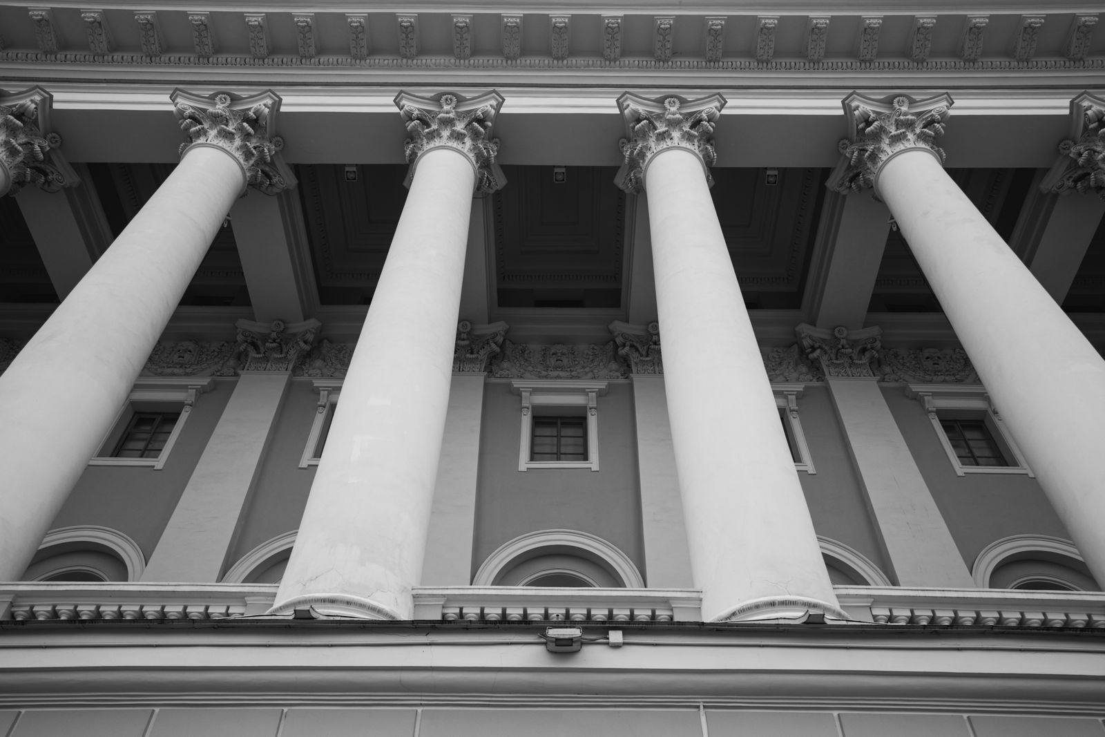 Classical stone columns of a historic financial building in black and white