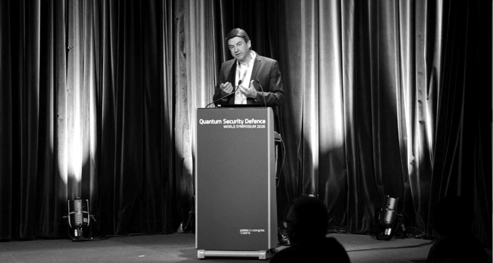 A keynote speaker at the QSECDEF World Symposium lectern