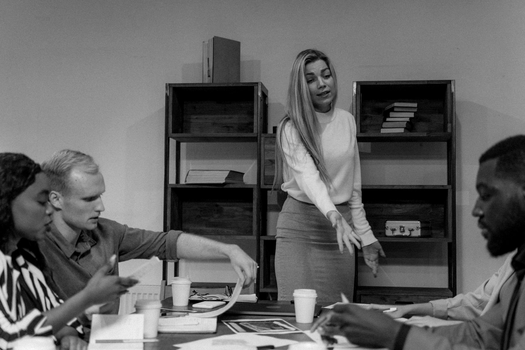A team working through a plan together around a meeting table