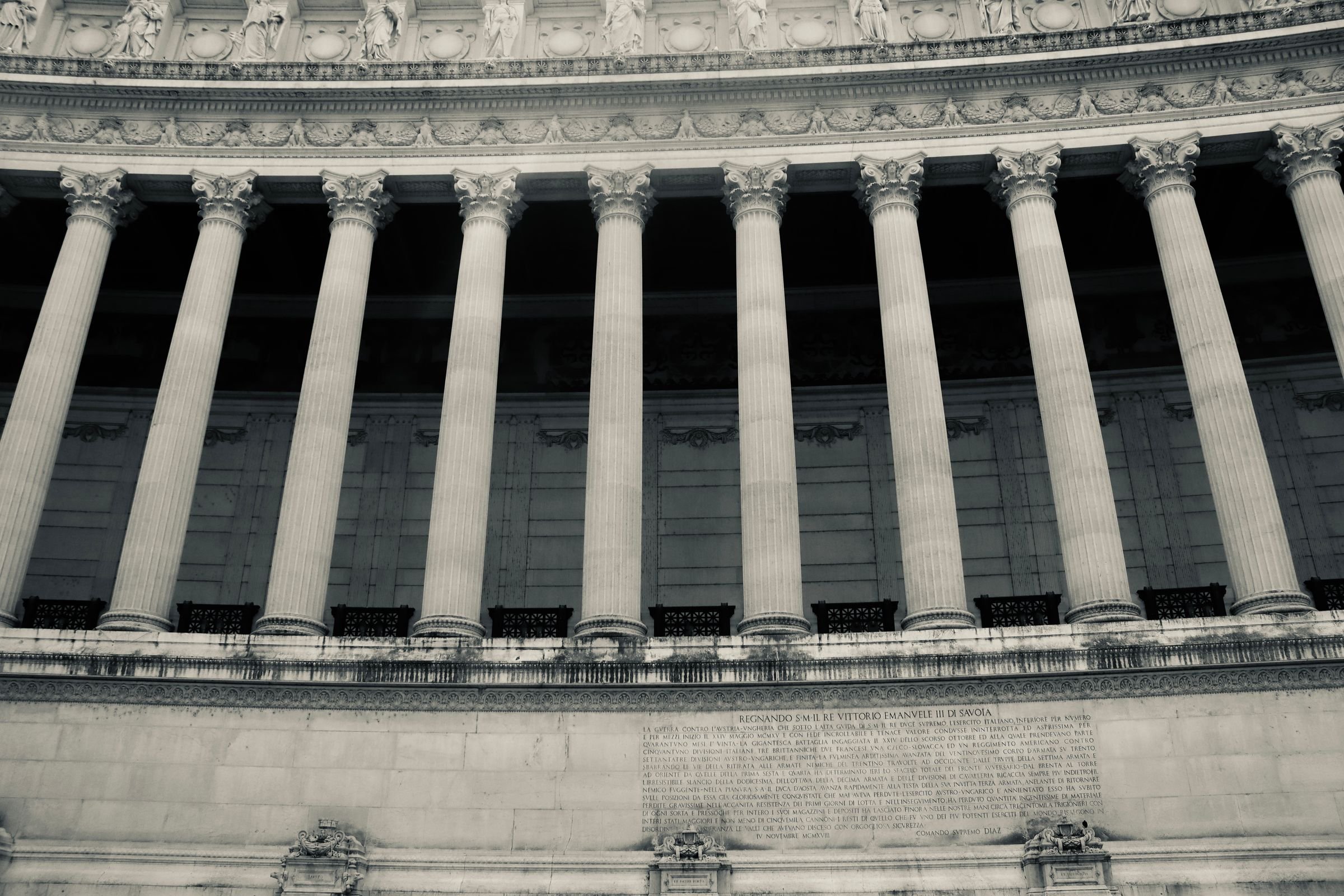 A curved colonnade of a neoclassical government building.