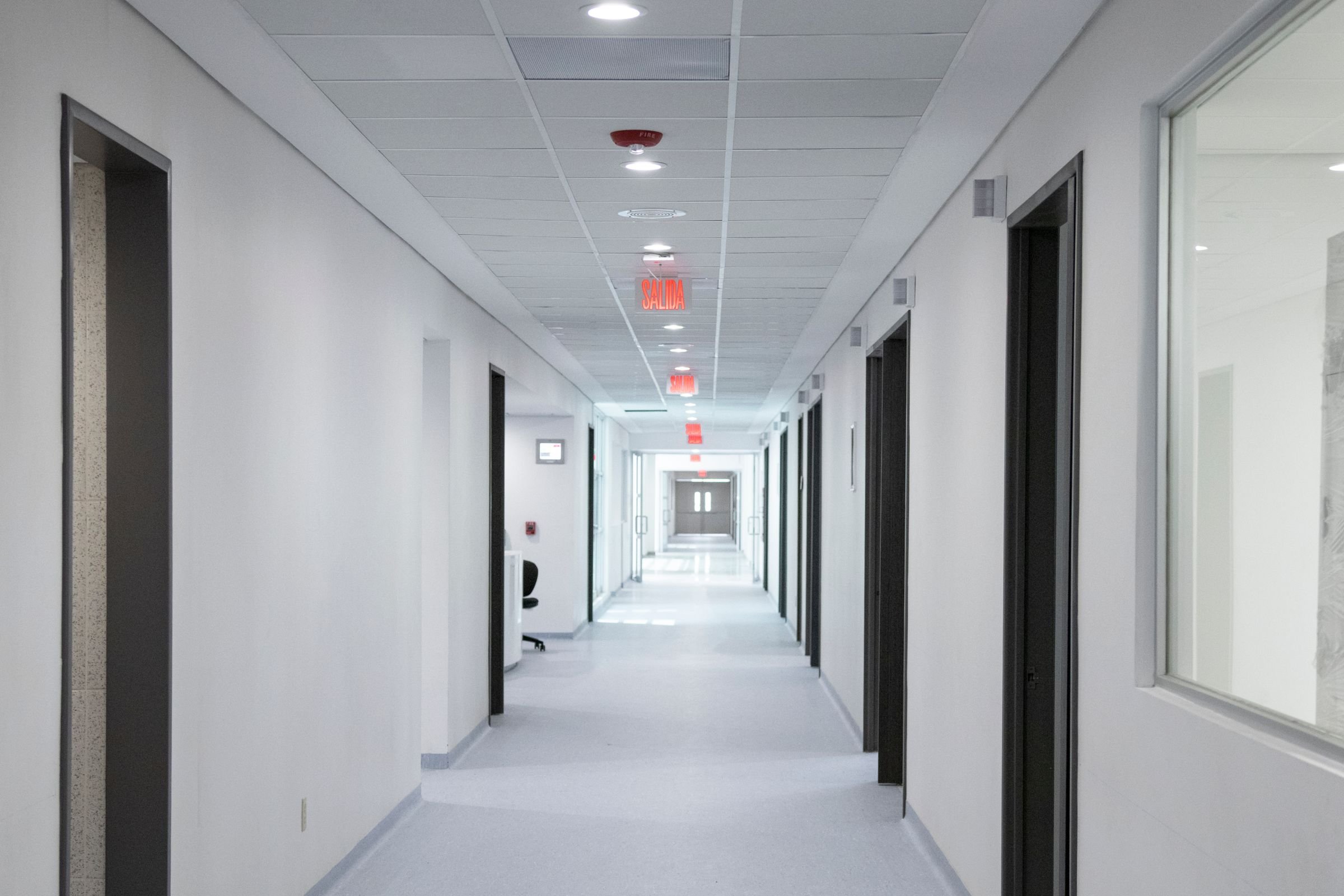 A long, brightly lit hospital corridor