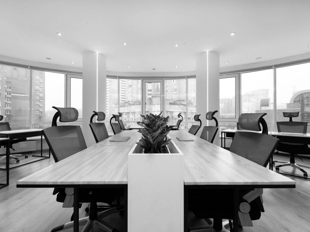 An empty boardroom with a long table, in black and white