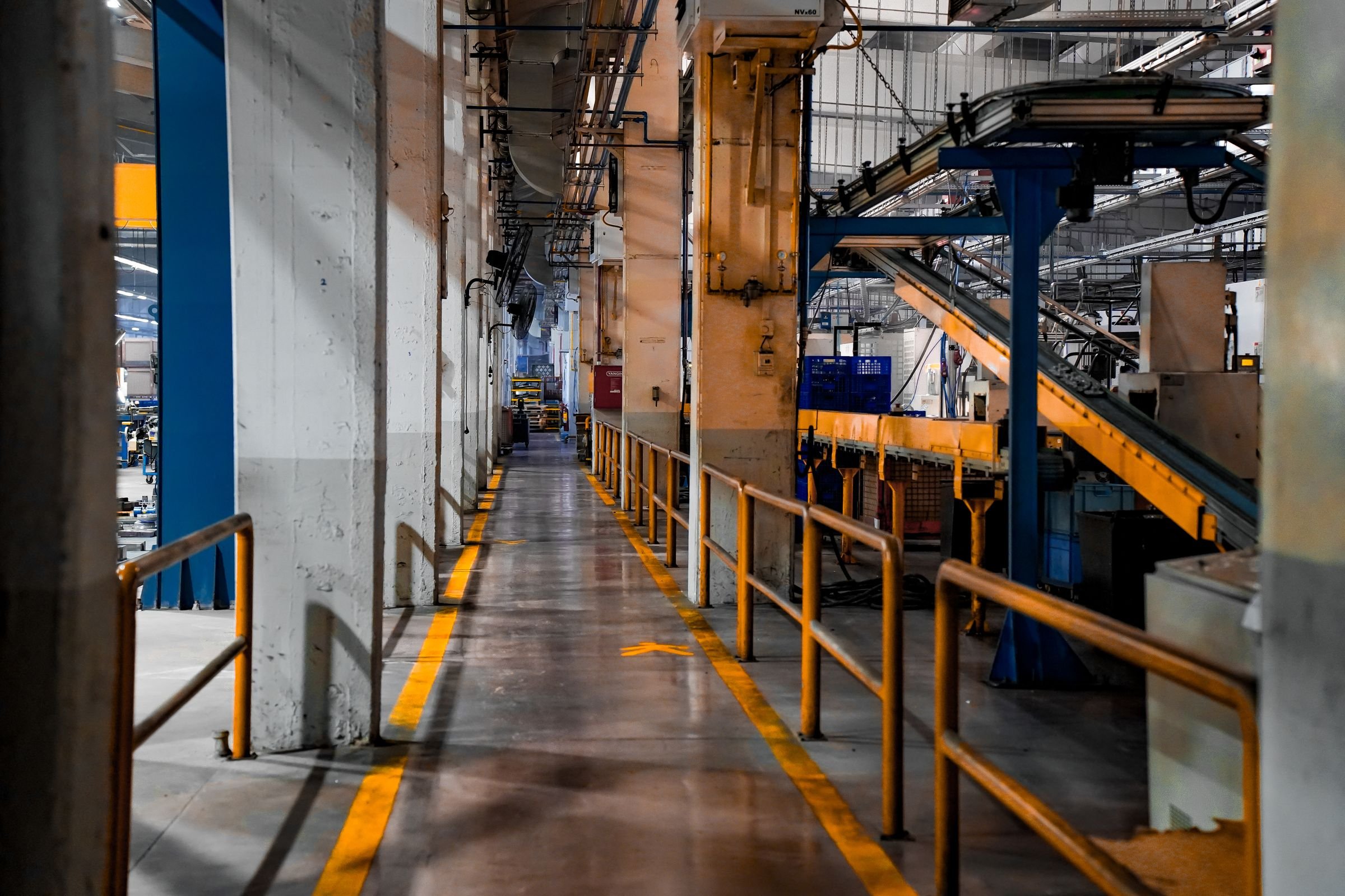 The floor of a vehicle plant with conveyors and walkways