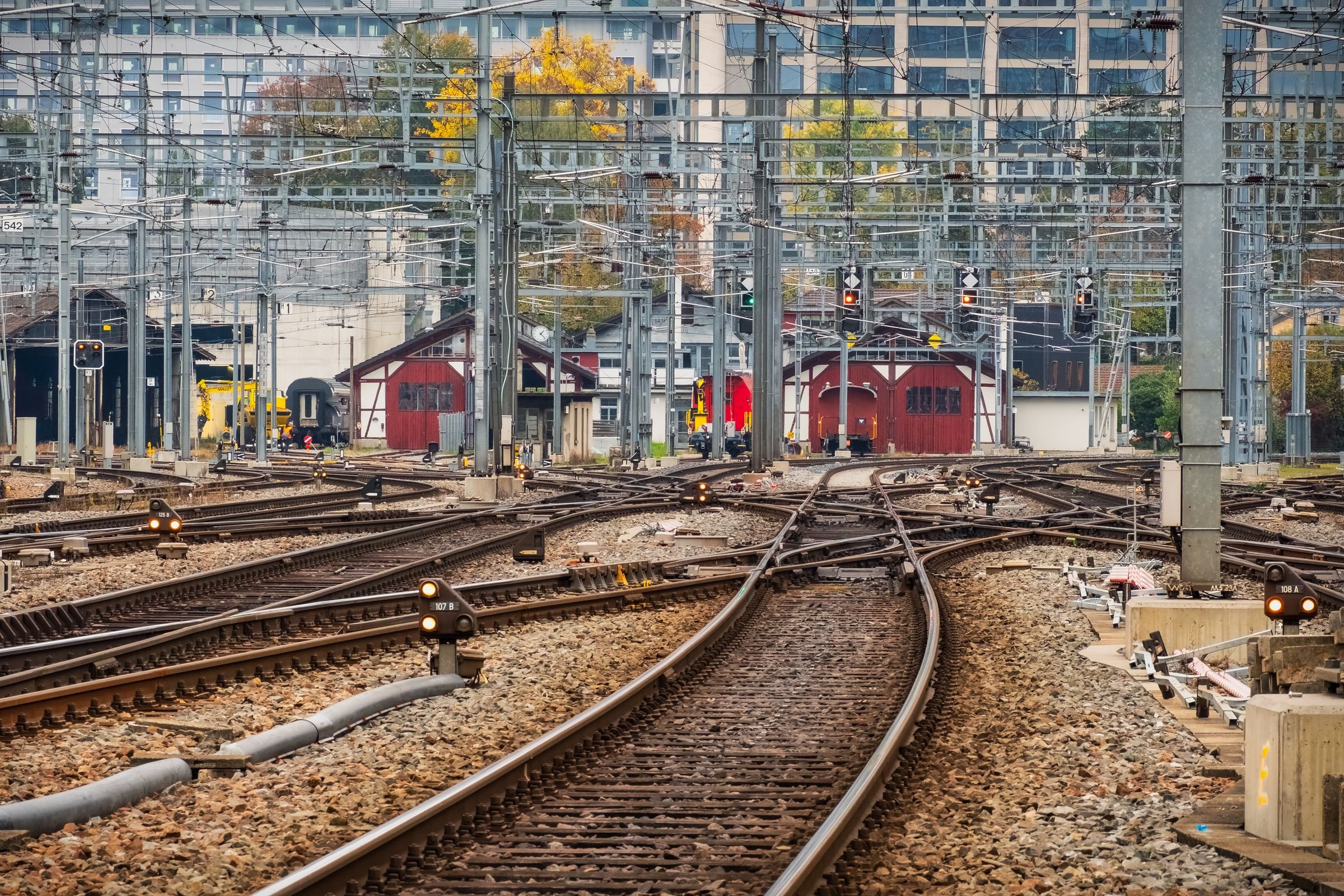 Converging railway tracks and signals outside a station